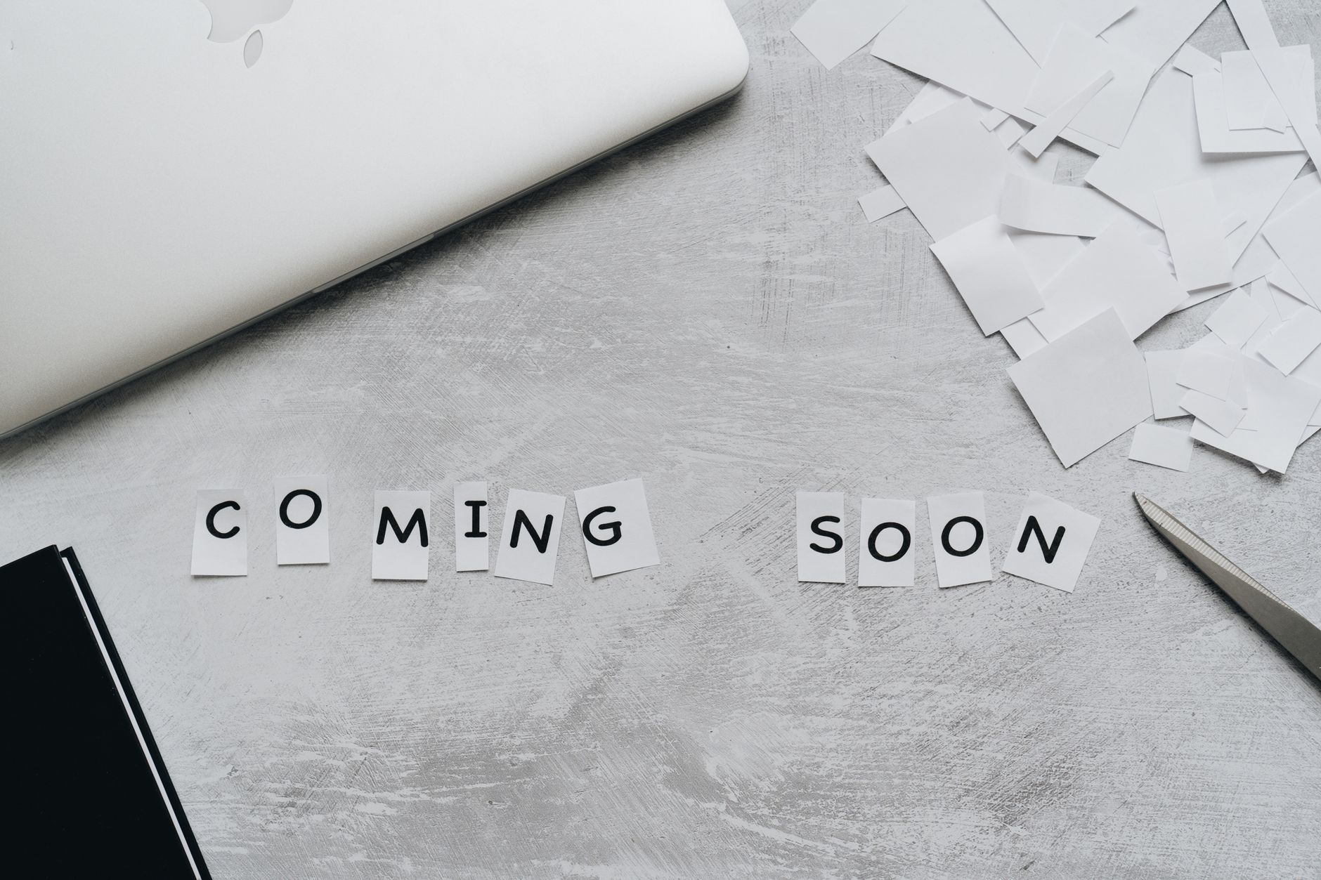 paper cut out of letters forming the phrase coming soon